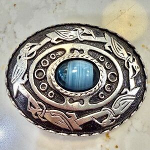 Silver-tone metal brooch with blue glass cabochon center and Celtic Bird